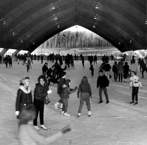 Students and area children skate in the newly opened UConn Ice Rink in 1965. The rink was home to the ice hockey team. Only a boat-shaped roof protected skaters from the elements, and many fans (and former hockey team members) can remember blustery cold winds blowing through the structure. The old ice rink was demolished to make way for the Ice Arena that opened in 1998. [University Archives]